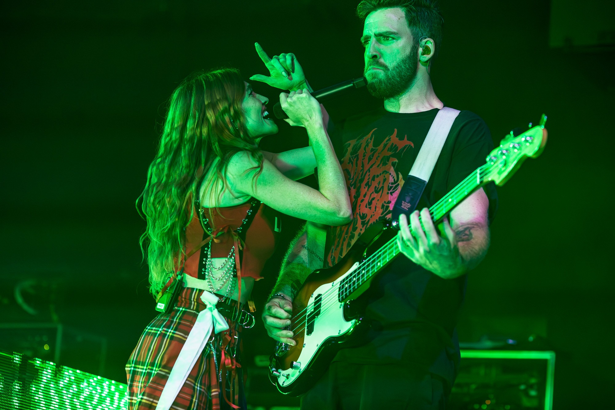 Mandy Leed of MisterWives singing to guitarist